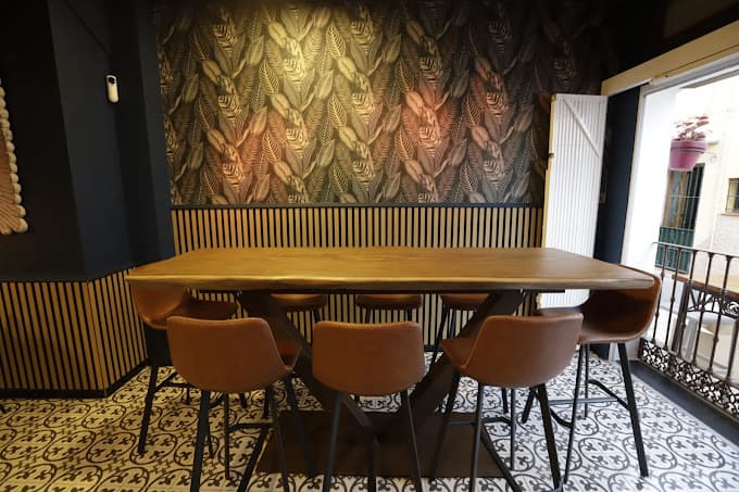 Sala interior con pared de vinos y fotografías antiguas